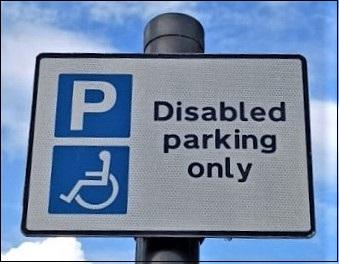 Parking sign with a white P in a blue square saying disable parking only.