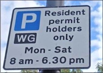 Parking sign saying resident permit holders only.