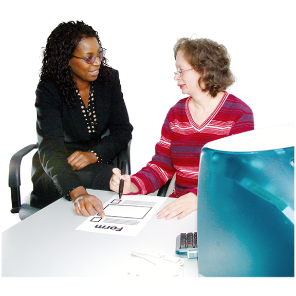 A woman helping another woman with a form