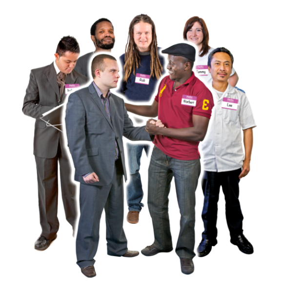 A group of people with name badges welcoming someone