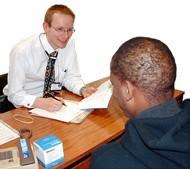 A man talking to a health worker