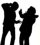 Silhouette of a person physically threatening another