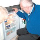 A man fixing a fridge