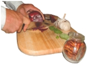 Hands cutting vegetables on a chopping board