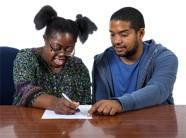 A woman a carer filling out a form