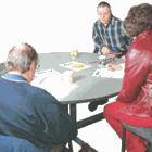 Three people meeting around a table