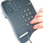 A hand dialling a telephone