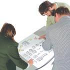 3 people working on a chart