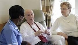 A nurse talking to an elderly couple