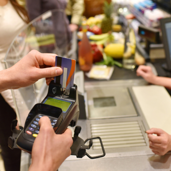 card reader being used to pay for groceries at a register