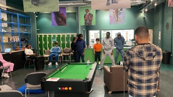 Young people playing pool at Rising Green