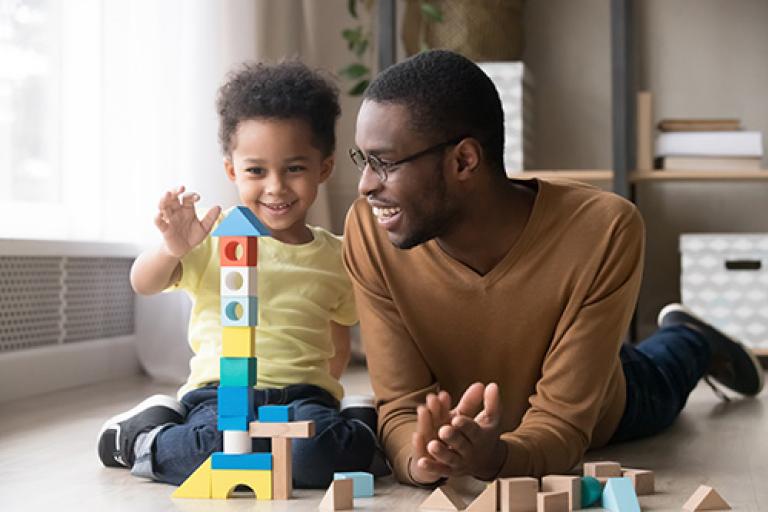 Father and son playing and smiling