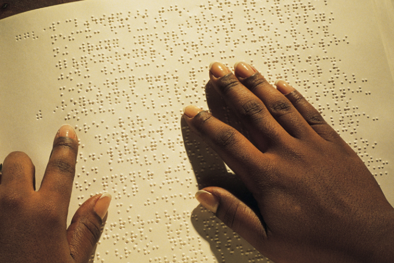 young person reading braille 