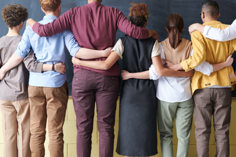 image of adults facing away from the camera linking arms together