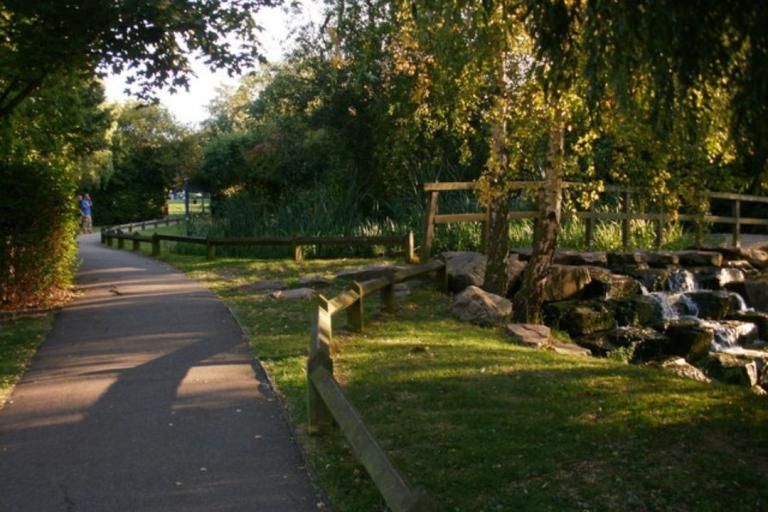 Path at Stationers Park with trees, grass and a bridge