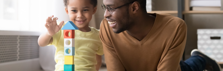 Father and son playing and smiling