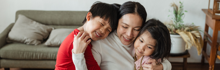 Mother hugging two children