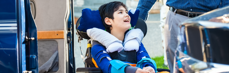 young person in a wheelchair smiling