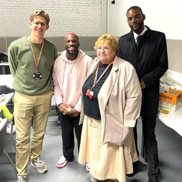 Young adult smiling with Cllrs and local advocate