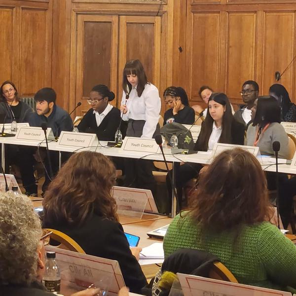 young person speaking in a room for a special full council meeting