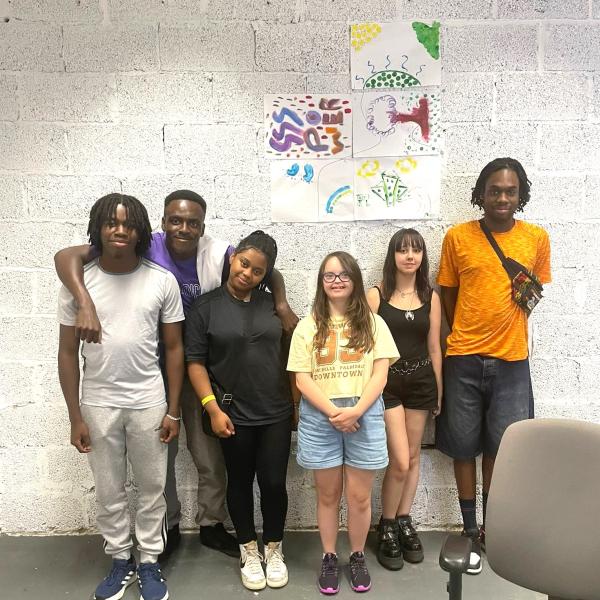 six young people standing together smiling